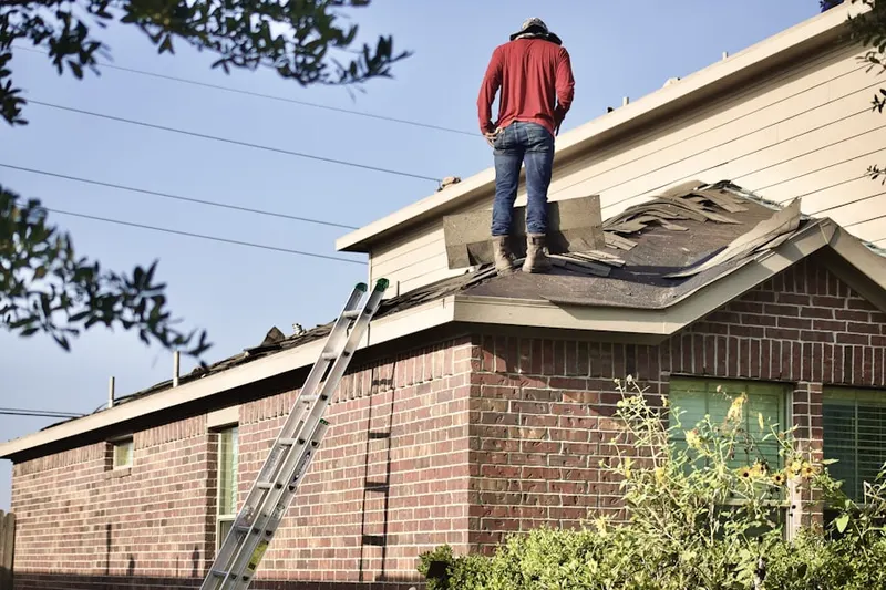 Professional roofer working on a residential roof in Atwater